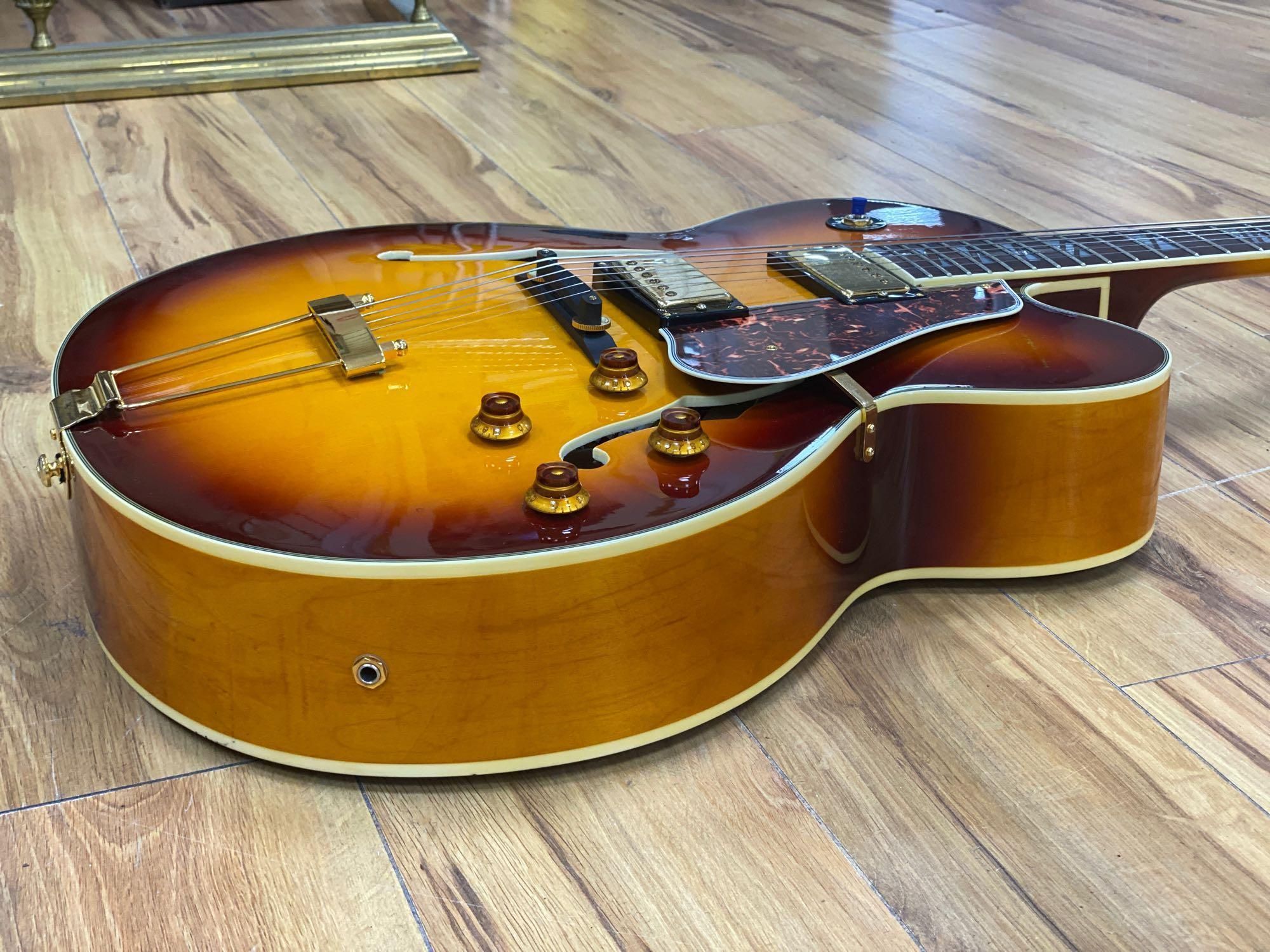 An Aria Career electric acoustic and jazz guitar, in soft case